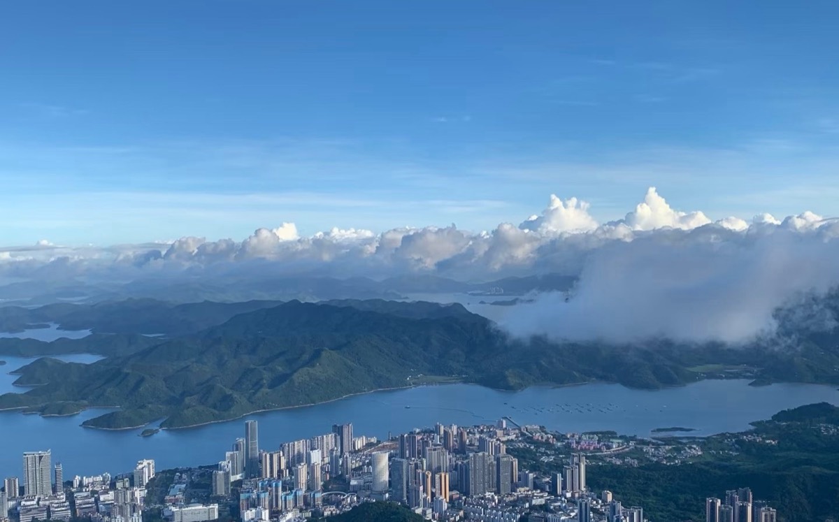 Daytime panorama from Wutong Mountain: reservoir, hills, clouds and the city below